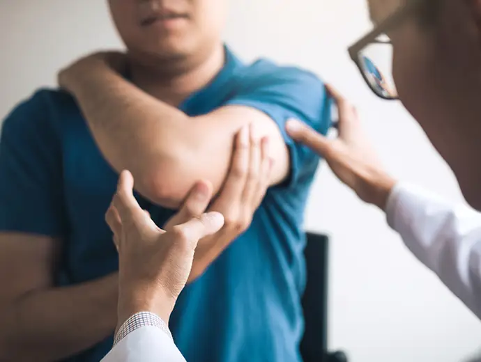 Physical therapists are checking patients elbows at the clinic office room