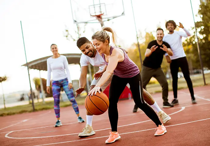Young people playing in the park without pain thanks to pain management in Sappington MO