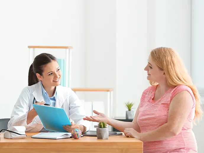 doctor consulting woman in clinic