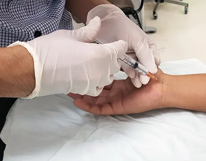 Doctor giving the injection to patient ‘s hand for treatment of neuropathy